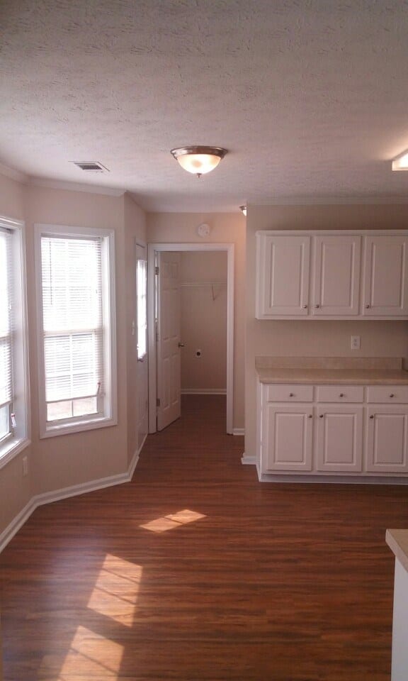 After: a modern kitchen, with new wood floors and new cabinets