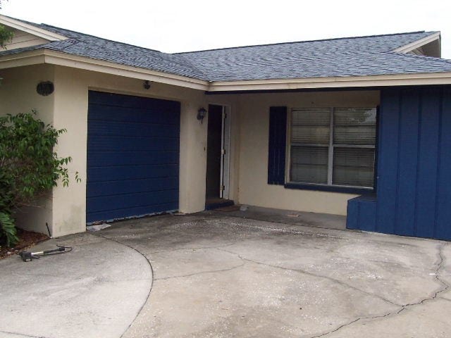 Before: an outdated exterior with a cracked cement driveway