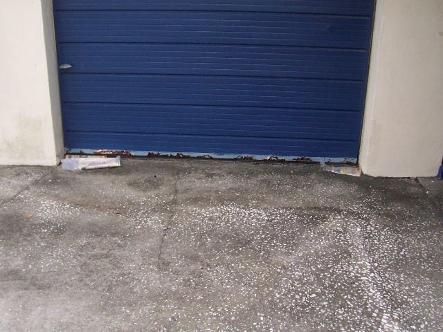 Before: a damaged and unsealed garage door